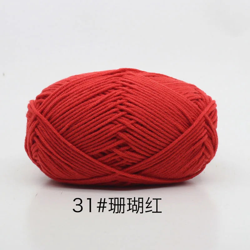 A ball of bright red 4-ply milk cotton yarn for knitting and crochet.