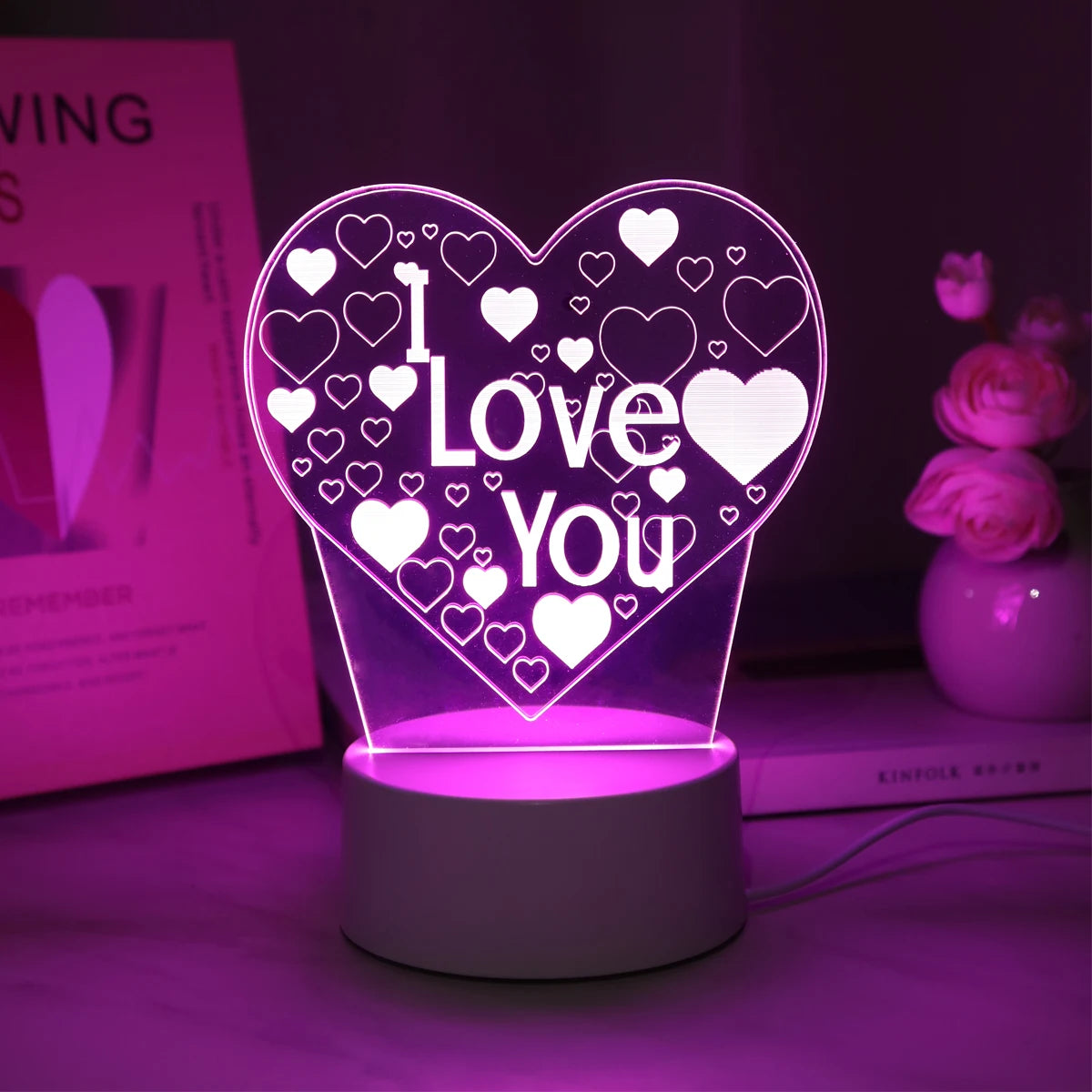 A glowing pink LED heart night light with a 'I Love You' design and surrounding small hearts.