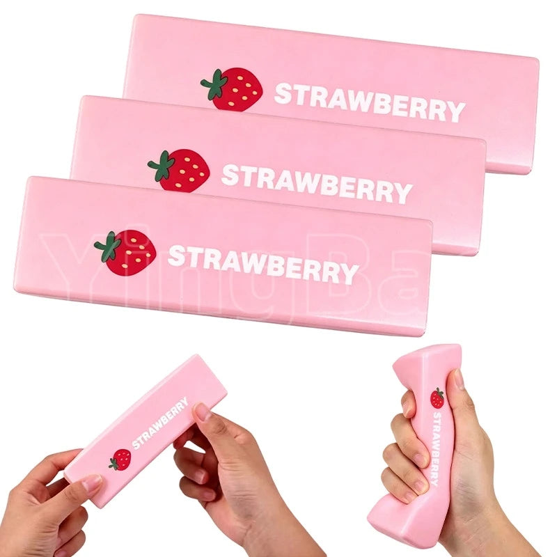 Pink squishy strawberry shaped fidget toy with the word STRAWBERRY printed on it