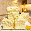 Giant cheese squeeze toy showing several blocks of thick yellow cheese-colored squishy material