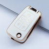A white and gold protective TPU key fob cover for a vehicle, shown in a diagonal angle.