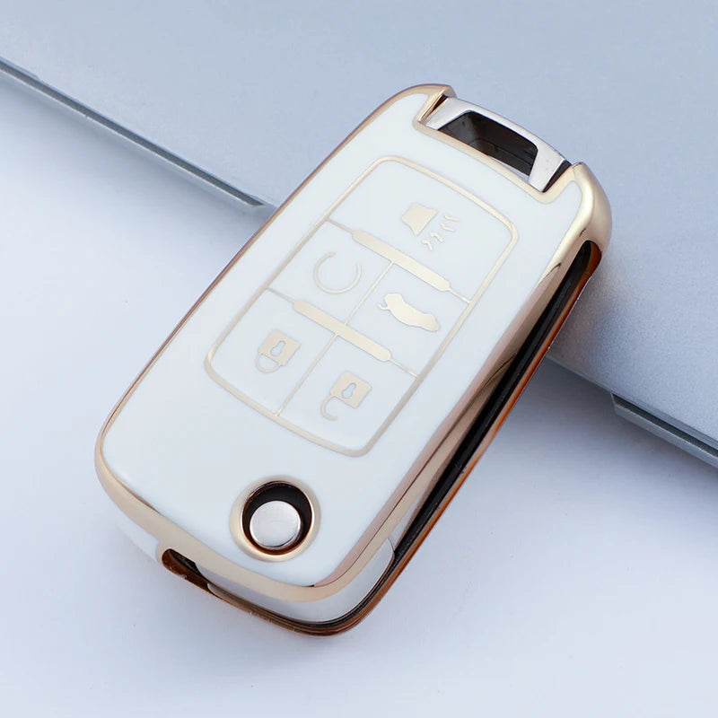A white and gold protective TPU key fob cover for a vehicle, shown in a diagonal angle.