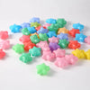 A pile of colorful, non-toxic ball pit balls in various shades of blue, green, pink, and yellow.