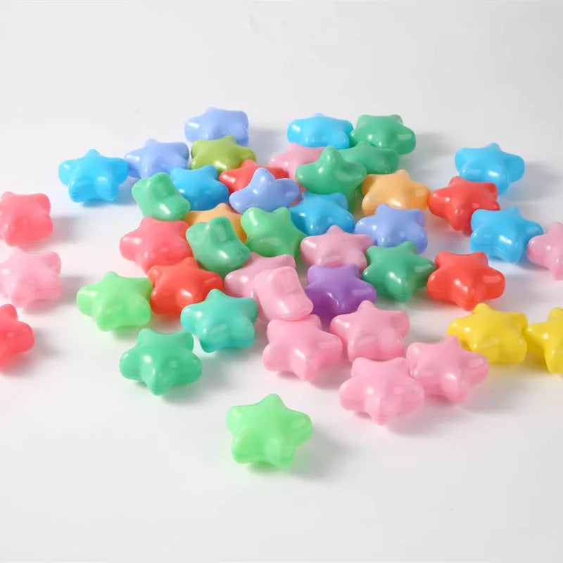 A pile of colorful, non-toxic ball pit balls in various shades of blue, green, pink, and yellow.