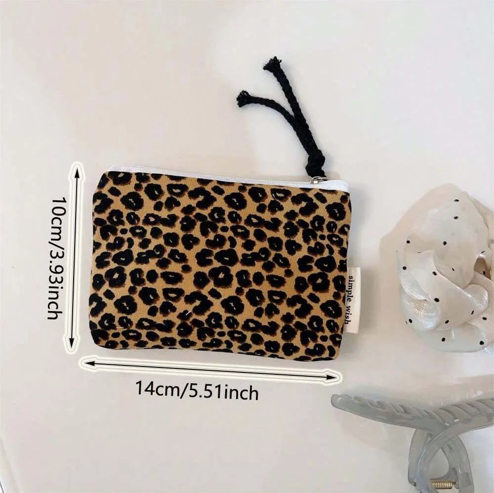 A leopard print cosmetic bag with a secure zipper is shown next to a measuring tape.