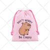 Pink drawstring storage bag featuring a cute capybara illustration with the text Don't Worry Be Cappy