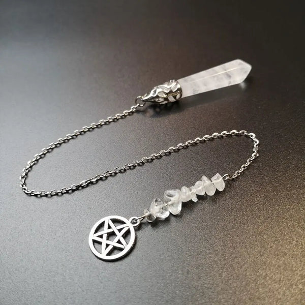 A silver chain necklace featuring a natural white quartz crystal pendulum with a decorative head.