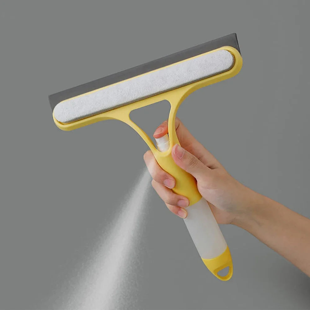 A hand holds a yellow and gray multi-function window cleaning tool with a soft sponge head, spraying water.