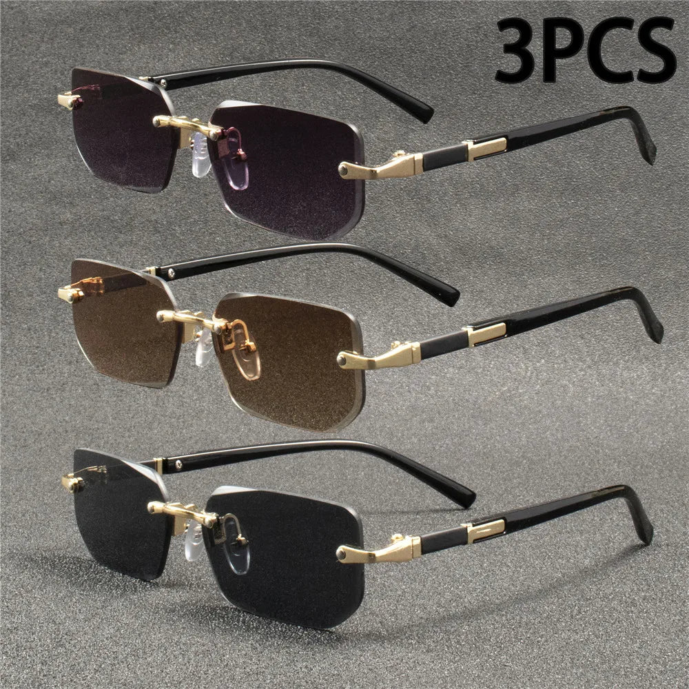 Trois paires de lunettes rectangulaires sans monture en noir et or sur fond gris.