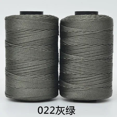 Two spools of dark gray 3-ply polyester knitting yarn for crochet and hand crafts