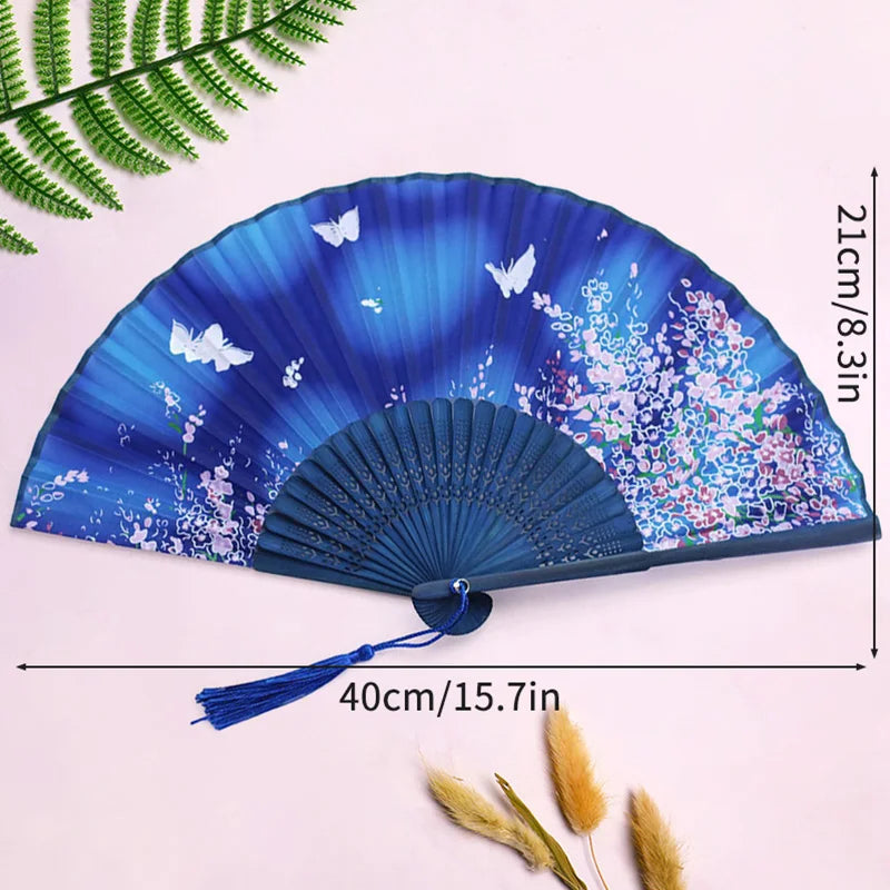 A blue and purple vintage lace folding hand fan with a durable handle displayed on a light background.