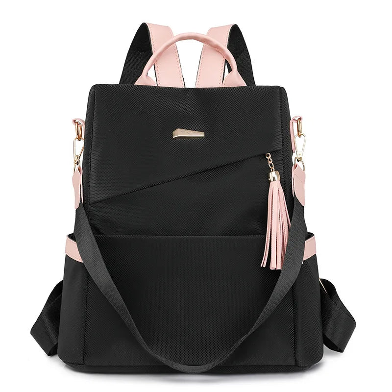 Black vegan leather backpack with pink accents and a laptop compartment.