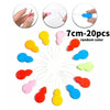 A collection of 20 random color plastic needles and threaders shown in various angles.