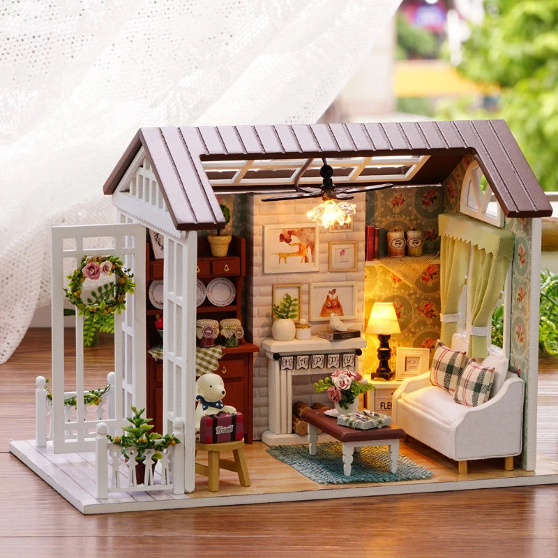 A wooden miniature dollhouse kit featuring a rustic cabin facade with interior details and LED lighting.