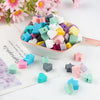 A bowl filled with colorful silicone crown star heart beads for DIY jewelry making, displayed on a white background.