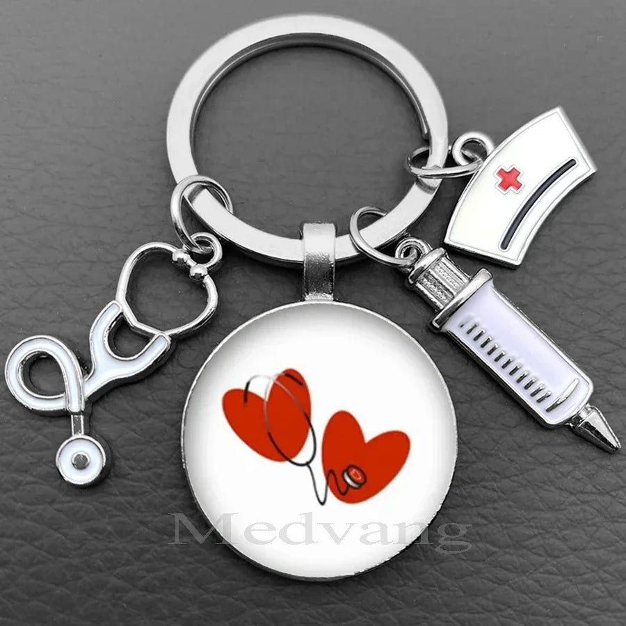 Silver nurse keychain featuring a red heart design on a circular pendant and a glass dome charm