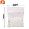 A white mesh laundry bag with pink trim, measuring 30cm by 40cm.