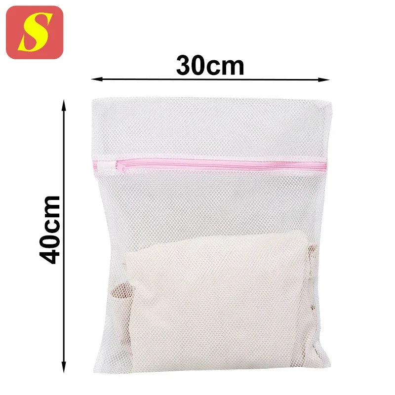 A white mesh laundry bag with pink trim, measuring 30cm by 40cm.