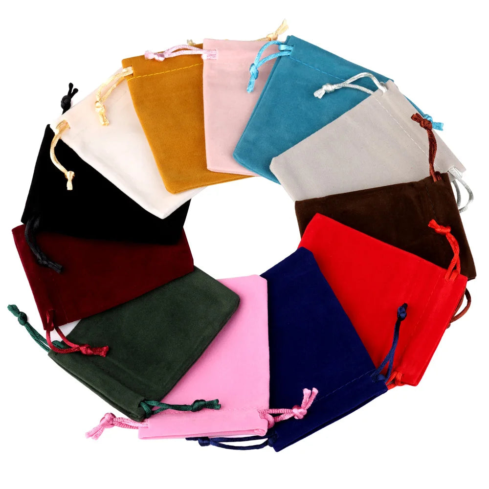 A circular arrangement of velvet drawstring jewelry pouches in various colors including yellow, pink, blue, green, and red.