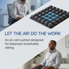 A person sits on an air-cell cushion designed for balanced, breathable sitting.