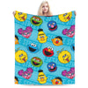 A colorful flannel throw blanket featuring multiple smiling yellow and blue Sesame Street characters.