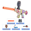 An M416 electric gel ball blaster toy gun with an orange barrel and colorful body, shown alongside its components.