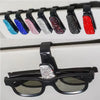 A display of various colored crystal rhinestone sunglasses clips arranged in a row.