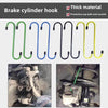 A set of thick metal brake cylinder hooks in green, blue, black, and yellow are shown for auto repair.