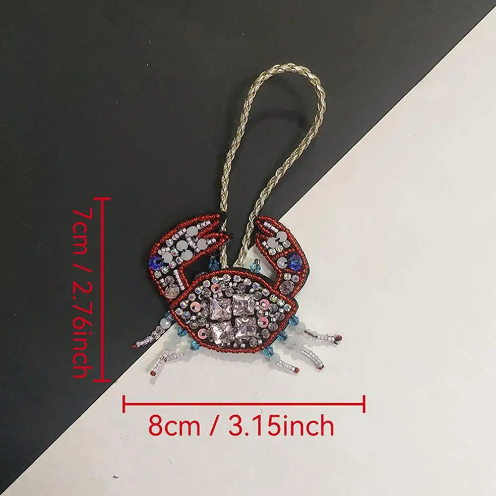 Handcrafted rhinestone bag charms featuring a sequin octopus and turtle pendant keychains