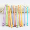 A set of twelve colorful plastic crochet hooks in various sizes arranged on a white background.
