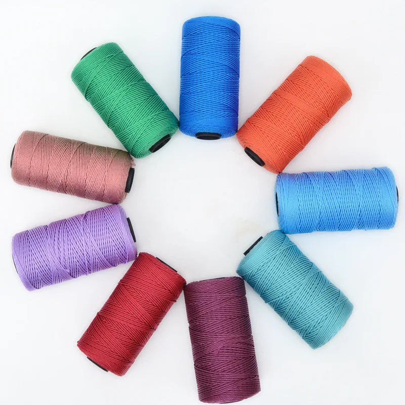 A collection of colorful 3-ply polyester knitting yarn spools in various shades including green, blue, orange, and purple.