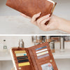 A brown leather wallet with gold accents and a VIP card is shown being held by a hand.