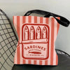 A pink and orange striped canvas tote bag featuring a graphic print of sardines in olive oil.