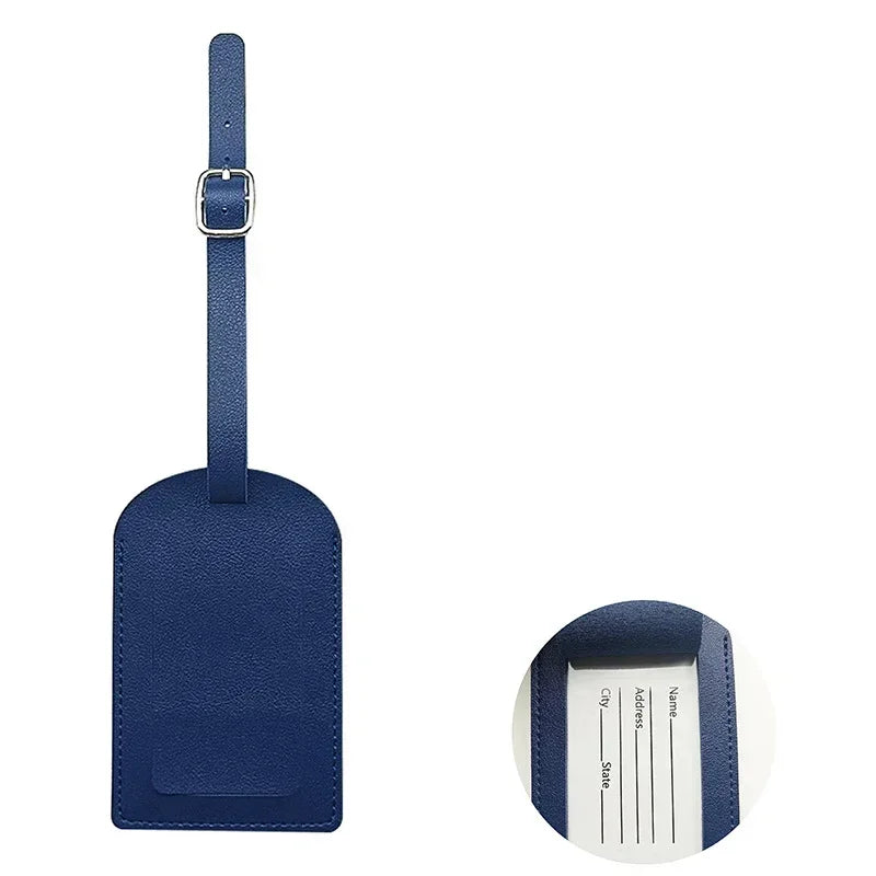 A dark blue PU leather luggage tag with a silver clip and white name and address lines.
