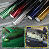 A display of gradient car window tint film rolls showing various colors like green, red, blue, and gold.
