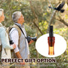 A glass bottle of a portable crow call whistle shown next to people in an outdoor setting.