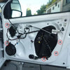 Close-up view of a white car door showing self-locking nylon cable tie buckles and related hardware.