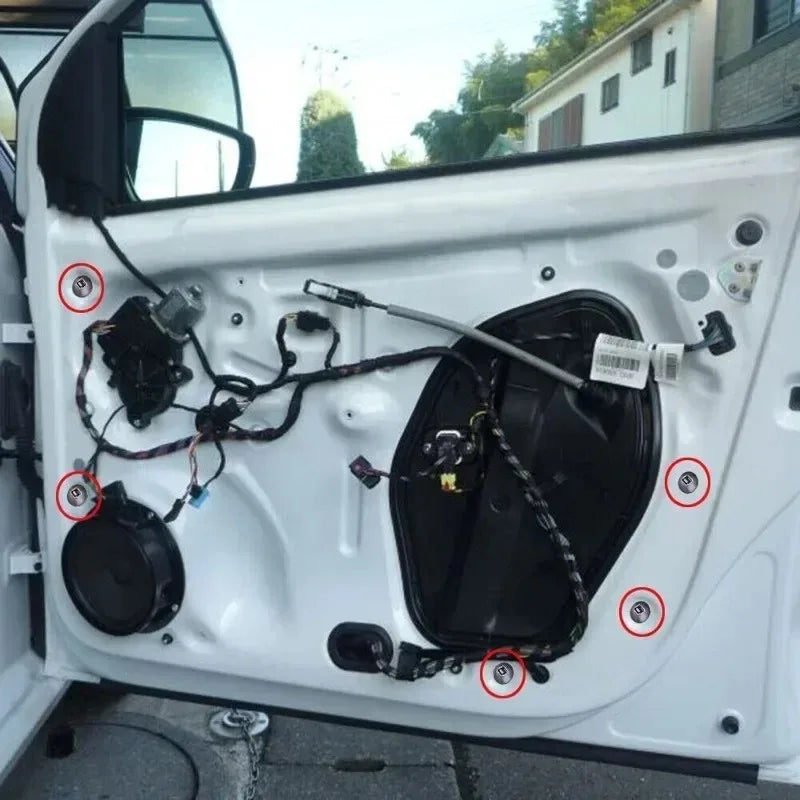 Close-up view of a white car door showing self-locking nylon cable tie buckles and related hardware.