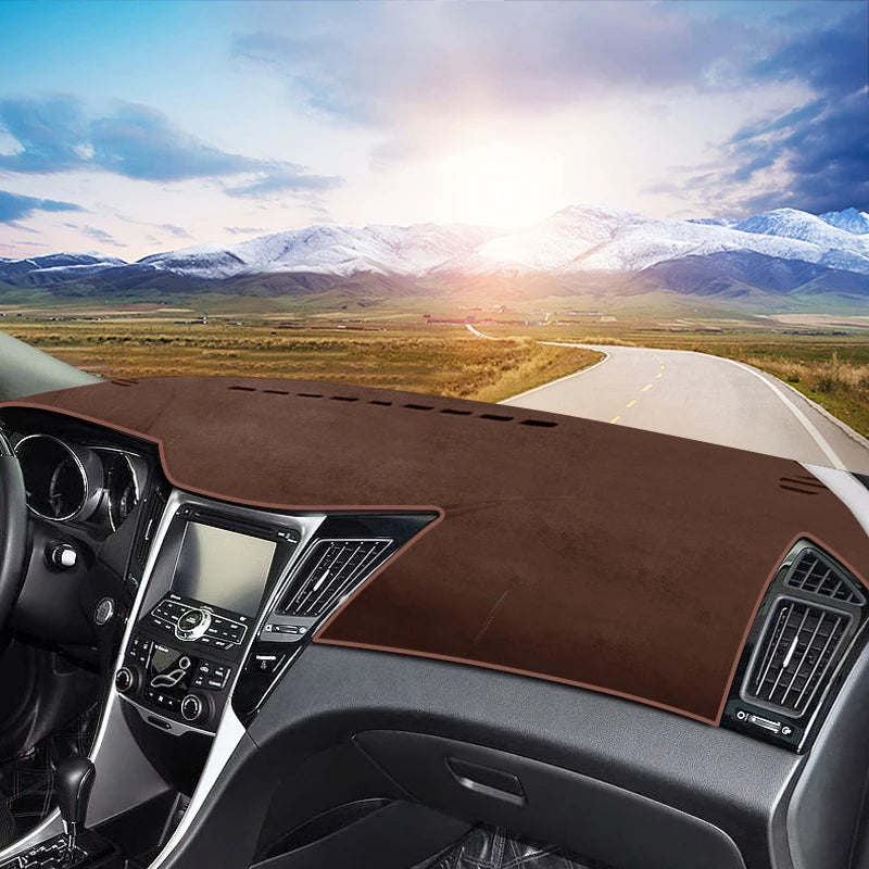 A custom fit dashboard sun shield is installed on a car, featuring a brown material and visible interior components.