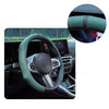 A close-up view of a green perforated leather steering wheel cover installed on a car's steering wheel.