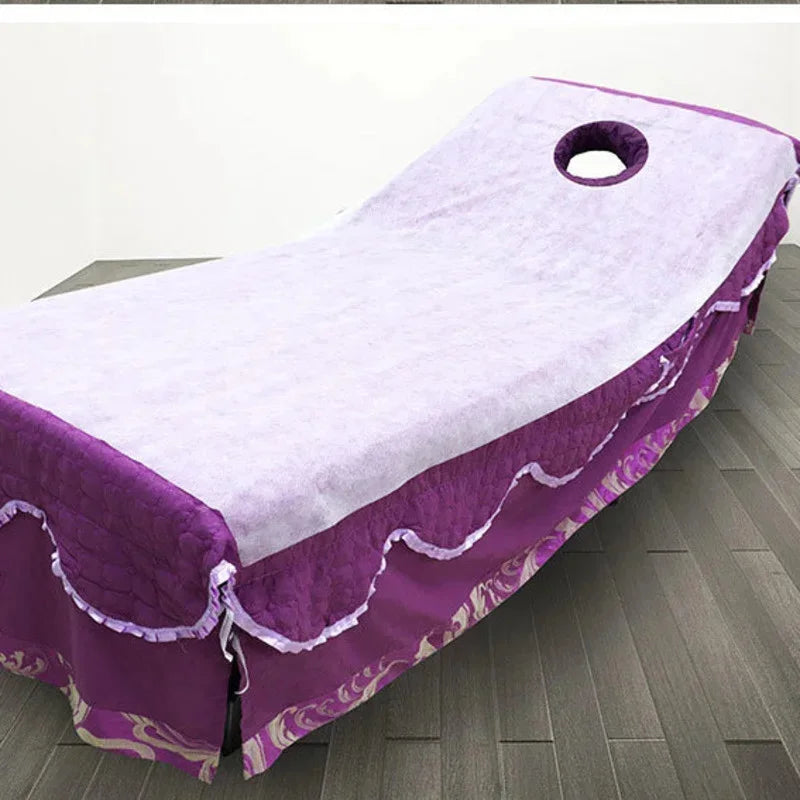 Purple disposable bed sheets with white trim and a circular hole, laid out on a floor.