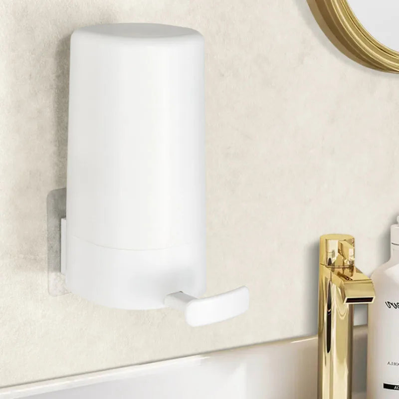 A white soap bar grinder and dispenser with a wall-mount option mounted on a light-colored wall.