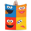A colorful flannel throw blanket featuring smiling faces from Sesame Street characters.