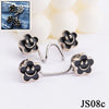 Silver and black flower-shaped buttons for adjusting jeans
