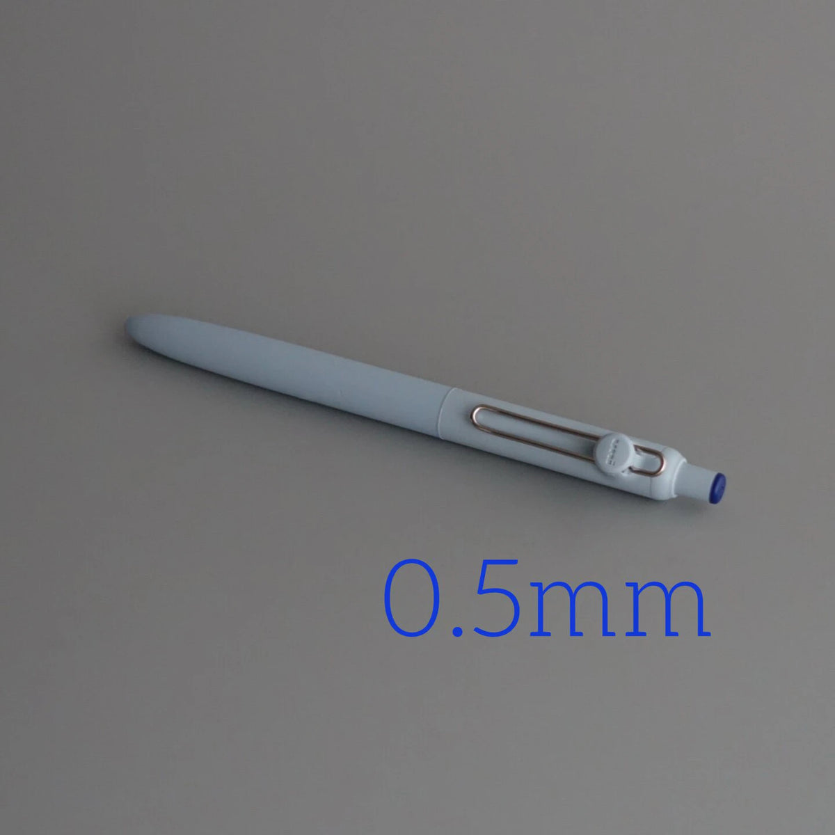 A close-up view of a light gray Uni ZENTO Quick-Dry Gel Pen with a 0.5mm tip.