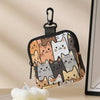 A black mini coin purse featuring a pattern of various cats in shades of brown, gray, and white.