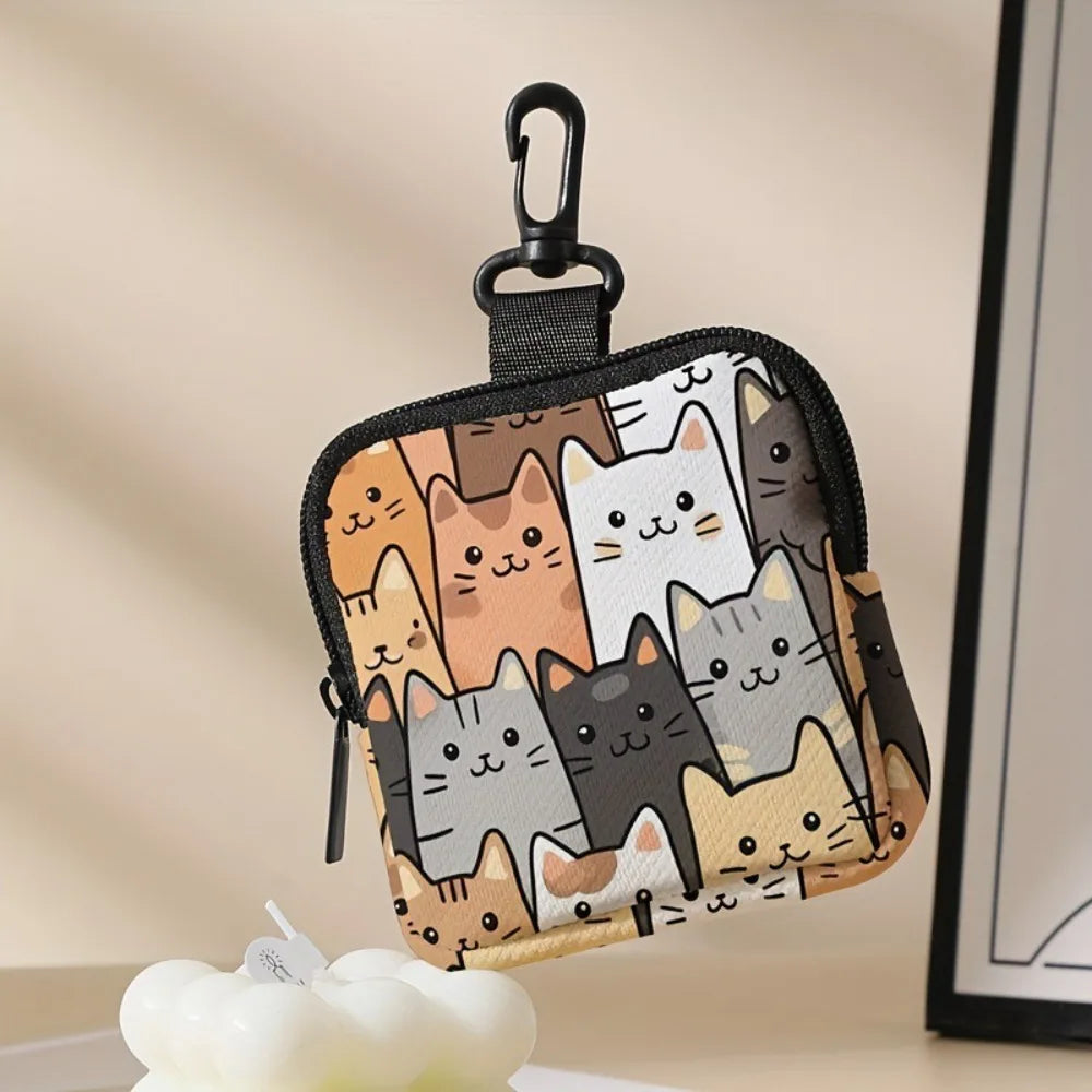 A black mini coin purse featuring a pattern of various cats in shades of brown, gray, and white.