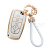 A white and gold TPU car key fob cover case with a chain and white cord.