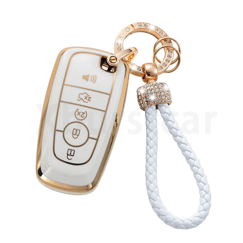 A white and gold TPU car key fob cover case with a chain and white cord.