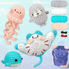 A collection of crocheted animal figures and yarn, including a pink dinosaur, gray monster, and a white creature, packaged in